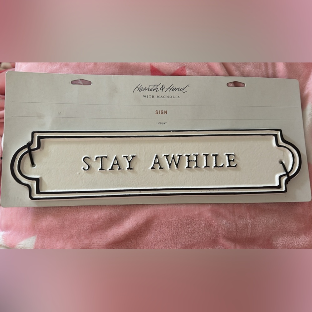 Hearth and hand with magnolia STAY AWHILE sign.